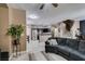 Comfortable living area featuring an open floorplan, plush sofa, and easy access to kitchen and staircase at 5509 Ante Up Ct # 102, Las Vegas, NV 89122