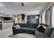 View of open living area with plush sectional sofa and staircase, offering an inviting and spacious feel at 5509 Ante Up Ct # 102, Las Vegas, NV 89122