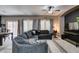 Open-concept living area with a large couch, dining table, and modern lighting at 5509 Ante Up Ct # 102, Las Vegas, NV 89122