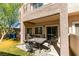 This outdoor patio has a dining table with seating, and direct access into the home through a sliding glass door at 5509 Ante Up Ct # 102, Las Vegas, NV 89122