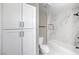 Clean bathroom features white cabinets and marble tiling in the bathtub and shower at 6 Megan Dr, Henderson, NV 89074