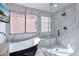 Bright bathroom features a modern soaking tub and glass enclosed shower with marble-style tile at 6 Megan Dr, Henderson, NV 89074