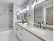 Bright bathroom with a dual sink vanity and marble tiled shower and bath at 6 Megan Dr, Henderson, NV 89074