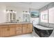 Bright bathroom features a modern soaking tub, dual sink vanity and a wall mounted TV at 6 Megan Dr, Henderson, NV 89074