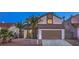 Charming two-story home featuring a well-maintained yard with mature palm trees at 6 Megan Dr, Henderson, NV 89074