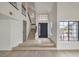 Bright foyer with high ceilings, staircase, and large windows, creating a welcoming entrance at 6 Megan Dr, Henderson, NV 89074
