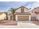 Charming two-story home with a well-maintained lawn, mature palms and two-car garage at 6 Megan Dr, Henderson, NV 89074