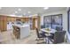 Modern kitchen featuring an island with seating, stainless steel appliances, and an adjacent dining area with backyard access at 6 Megan Dr, Henderson, NV 89074