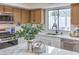 A modern kitchen features stainless appliances, a large counter island, and views of the backyard at 6 Megan Dr, Henderson, NV 89074