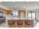 The kitchen features an island with seating, white countertops, and a sliding glass door to the backyard at 6 Megan Dr, Henderson, NV 89074
