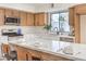 Bright kitchen boasts stainless steel appliances, quartz countertops, and bar seating for casual dining at 6 Megan Dr, Henderson, NV 89074
