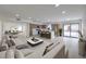 Bright, open-concept living room showcases modern décor and seamlessly connects to the kitchen and outdoor patio at 6 Megan Dr, Henderson, NV 89074