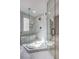 Glass enclosed shower features marble style tiling, built in shower bench and rainfall shower head at 6 Megan Dr, Henderson, NV 89074