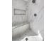 Detail of the shower featuring marble style tiling, shower bench and rainfall shower head at 6 Megan Dr, Henderson, NV 89074