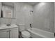 This bathroom features a tiled shower and bath, mirror, and sink with cabinet at 6225 Rassler Ave, Las Vegas, NV 89107