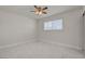 A bright bedroom features marble-style tiling, a ceiling fan, and a window at 6225 Rassler Ave, Las Vegas, NV 89107