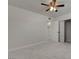 A bright bedroom features a ceiling fan, tiled flooring, and a closet with mirrored doors at 6225 Rassler Ave, Las Vegas, NV 89107