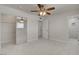 Bright bedroom features a ceiling fan, tiled flooring, and a closet with mirrored doors at 6225 Rassler Ave, Las Vegas, NV 89107