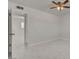 A bright bedroom features marble-style tiling and a ceiling fan at 6225 Rassler Ave, Las Vegas, NV 89107