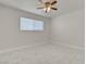 A bright bedroom features marble-style tiling, a ceiling fan, and a window at 6225 Rassler Ave, Las Vegas, NV 89107