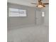 Bright bedroom with window, marble tile flooring, and a ceiling fan at 6225 Rassler Ave, Las Vegas, NV 89107