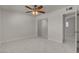 Bedroom featuring closet, mirrored doors, tile flooring, and ceiling fan at 6225 Rassler Ave, Las Vegas, NV 89107