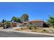 Well-maintained single-story home with desert landscaping and a long driveway leading to a carport at 6225 Rassler Ave, Las Vegas, NV 89107