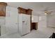 Bright, updated kitchen with new appliances, white tile flooring, and dark wood cabinetry with ample storage at 6225 Rassler Ave, Las Vegas, NV 89107