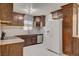 Updated kitchen with white tile floors, herringbone backsplash, stainless steel appliances, and wooden cabinets at 6225 Rassler Ave, Las Vegas, NV 89107