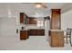 Updated kitchen features wood cabinetry, stainless appliances, tile backsplash and white tile flooring at 6225 Rassler Ave, Las Vegas, NV 89107