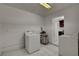 Bright laundry room features tile flooring, washer, dryer, and access to the kitchen at 6225 Rassler Ave, Las Vegas, NV 89107