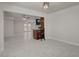 Open-concept living room with white marble floors and breakfast bar to kitchen at 6225 Rassler Ave, Las Vegas, NV 89107