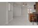Open-concept living room featuring white marble floors and access to a breakfast bar at 6225 Rassler Ave, Las Vegas, NV 89107