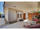 Covered outdoor patio with grill and seating area leading into home at 6225 Rassler Ave, Las Vegas, NV 89107