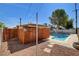 Backyard pool area surrounded by desert landscaping and wood fence at 6225 Rassler Ave, Las Vegas, NV 89107