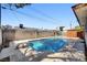 Backyard pool featuring a diving board, fence and desert landscaping at 6225 Rassler Ave, Las Vegas, NV 89107