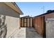 Backyard shed with double doors and fenced walkway at 6225 Rassler Ave, Las Vegas, NV 89107