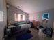 Vaulted ceiling bedroom with a double window letting in natural light and laminate floors at 6287 Stone Hollow Ave, Las Vegas, NV 89156