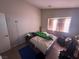 Bedroom featuring window for natural light, basic flooring, and neutral paint at 6287 Stone Hollow Ave, Las Vegas, NV 89156