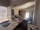 Living room featuring a vaulted ceiling and large windows at 6287 Stone Hollow Ave, Las Vegas, NV 89156