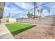 Fully fenced backyard featuring turf, a shed, and palm trees for privacy at 6308 Lawton Ave, Las Vegas, NV 89107