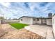 Large backyard with green grass patch, concrete patio and desert landscape at 6308 Lawton Ave, Las Vegas, NV 89107