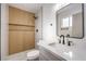 Stylish bathroom featuring wood accent wall, sleek black hardware, and quartz countertop at 6308 Lawton Ave, Las Vegas, NV 89107