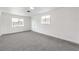 Bedroom featuring neutral carpet, fresh white paint, and a large window providing ample natural light at 6308 Lawton Ave, Las Vegas, NV 89107