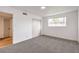 Bright bedroom featuring fresh gray carpet, a large window, and an inviting closet at 6308 Lawton Ave, Las Vegas, NV 89107