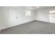 Bedroom features neutral carpet, fresh white paint, and a door to backyard for easy access at 6308 Lawton Ave, Las Vegas, NV 89107