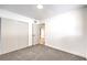 A bedroom featuring gray carpet, closet, and a door that leads to other areas at 6308 Lawton Ave, Las Vegas, NV 89107