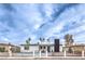 Charming single story home with desert landscape, blue front door and black accents at 6308 Lawton Ave, Las Vegas, NV 89107