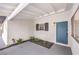 Charming front porch with desert landscape, blue front door and black accents at 6308 Lawton Ave, Las Vegas, NV 89107