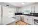 Modern kitchen featuring new white cabinets and a black backsplash at 6308 Lawton Ave, Las Vegas, NV 89107